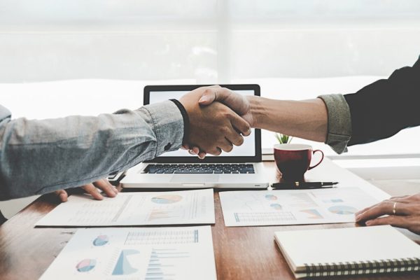 Successful businessmen handshaking after good deal. Business handshake and business people.